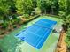 Aerial view of a community tennis court featuring a modern blue surface surrounded by green fencing at 2455 Talbot Ct, Sherrills Ford, NC 28673