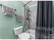 Updated bathroom boasts walk-in shower, new fixtures, and modern black and grey decor at 2510 Cranbrook Ln, Charlotte, NC 28207