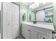 Stylish bathroom featuring a white vanity, sliding mirror door, and modern lighting fixtures at 2510 Cranbrook Ln, Charlotte, NC 28207
