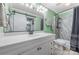 Renovated bathroom includes a new vanity, shower with updated tile, and a sliding mirror door at 2510 Cranbrook Ln, Charlotte, NC 28207