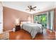 Cozy bedroom features a sliding glass door, wood floors, and a ceiling fan for added comfort at 2510 Cranbrook Ln, Charlotte, NC 28207
