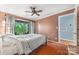 Relaxing bedroom with hardwood floors, a ceiling fan, and access to the home's private balcony at 2510 Cranbrook Ln, Charlotte, NC 28207