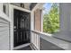 Charming front entrance with a black door, brick accents, and well-lit porch at 2510 Cranbrook Ln, Charlotte, NC 28207