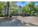 Multi-level condo building with ample parking and lush green surroundings at 2510 Cranbrook Ln, Charlotte, NC 28207