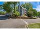 Three-story condo building featuring well-maintained landscaping and assigned parking at 2510 Cranbrook Ln, Charlotte, NC 28207