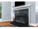 A modern black granite fireplace is equipped with a white mantle and a television above it at 2510 Cranbrook Ln, Charlotte, NC 28207
