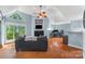 Bright living room with vaulted ceiling, fireplace, hardwood floors, and a large window at 2510 Cranbrook Ln, Charlotte, NC 28207