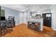 Open-concept room with hardwood floors, a fireplace, and adjacent to the kitchen at 2510 Cranbrook Ln, Charlotte, NC 28207