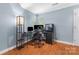 Work space with hardwood floors, a lamp, and a window that provides natural light at 2510 Cranbrook Ln, Charlotte, NC 28207