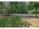 Beautifully landscaped backyard featuring a fire pit, lawn, and privacy fence at 2936 Saintfield Pl, Charlotte, NC 28270