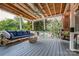 Relaxing covered patio with comfortable seating, a swing, and a ceiling fan at 2936 Saintfield Pl, Charlotte, NC 28270