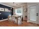Comfortable dining area with wooden table, white chairs, hardwood floors, and elegant wall decor at 2936 Saintfield Pl, Charlotte, NC 28270