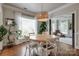 Bright dining area with round table, wicker light fixture, hardwood floors, and ample natural light at 2936 Saintfield Pl, Charlotte, NC 28270
