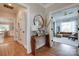 Inviting hallway featuring hardwood floors, stylish decor, and entryways leading to kitchen and living room at 2936 Saintfield Pl, Charlotte, NC 28270