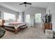 Serene main bedroom featuring vaulted ceilings, natural light, and a comfortable bed with neutral tones at 2936 Saintfield Pl, Charlotte, NC 28270