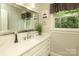 Brightly lit bathroom with white cabinetry at 3015 Rochester Ct, Monroe, NC 28110