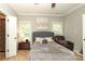 The primary bedroom features soft gray colors and natural light at 3015 Rochester Ct, Monroe, NC 28110