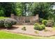 Stone entrance sign to Yorkshire community with landscaping and mature trees at 3015 Rochester Ct, Monroe, NC 28110