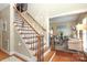 Inviting foyer with wood floors, staircase, and view into the living room at 3015 Rochester Ct, Monroe, NC 28110