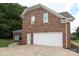A large two-car garage with a concrete driveway adds convenience to this brick home at 3015 Rochester Ct, Monroe, NC 28110