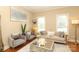 Comfortable seating area with neutral tones, large windows, and gold accents at 3015 Rochester Ct, Monroe, NC 28110