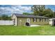 A green home has a backyard patio area with a grill and white fencing surrounding the property at 3545 Yorkland Dr, Hickory, NC 28601