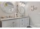 Bright bathroom with double sink vanity, granite counters, framed mirrors, and updated fixtures at 3545 Yorkland Dr, Hickory, NC 28601