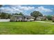 View of a green home with black shutters and a long driveway and beautiful front lawn at 3545 Yorkland Dr, Hickory, NC 28601