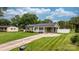 Well-manicured lawn leads to green home with attached carport and long driveway at 3545 Yorkland Dr, Hickory, NC 28601
