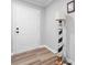 Hallway featuring a white door, hardwood floors and a decorative lighthouse lamp, providing ample light at 3545 Yorkland Dr, Hickory, NC 28601