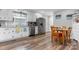 Open kitchen and dining area with stainless steel appliances, wooden chairs and a view of the backyard at 3545 Yorkland Dr, Hickory, NC 28601