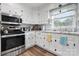 Functional kitchen with white cabinetry, granite countertops, stainless steel appliances, and a bright window at 3545 Yorkland Dr, Hickory, NC 28601