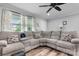 Spacious living room features a comfortable sectional sofa, a ceiling fan and natural light at 3545 Yorkland Dr, Hickory, NC 28601