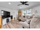 Inviting living room featuring a sectional sofa, modern ceiling fan, and stylish decor at 3545 Yorkland Dr, Hickory, NC 28601