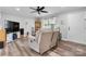 Bright living room boasts a recliner, a flat-screen television and an adjacent open doorway at 3545 Yorkland Dr, Hickory, NC 28601