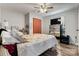 Spacious main bedroom with a ceiling fan, hardwood floors, closet with orange curtain and mirrored dresser at 3545 Yorkland Dr, Hickory, NC 28601