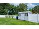 A metal storage shed sits within a fenced backyard with established landscaping and greenery at 3545 Yorkland Dr, Hickory, NC 28601