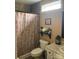Cozy bathroom with tile shower, decorative shower curtain, toilet, and decorative shelf at 3810 Spike Ln, Vale, NC 28168