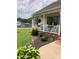 Inviting front porch with white railings, flower baskets, and manicured landscaping at 3810 Spike Ln, Vale, NC 28168