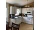Bright kitchen featuring white cabinets and countertops, stainless steel appliances, and a breakfast bar at 3810 Spike Ln, Vale, NC 28168
