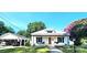 Charming single-story home with a metal roof, covered porch, carport and mature trees at 402 Madison St, Lincolnton, NC 28092