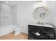 Modern bathroom featuring stylish vanity with a designer mirror and a tiled shower-tub combination at 4208 Antioch Church Rd # 1, Weddington, NC 28104