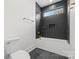 Bathroom with dark tile shower, white tub, and a toilet, complemented by modern fixtures at 4208 Antioch Church Rd # 1, Weddington, NC 28104