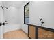 Bright bathroom features a modern vanity, soaking tub, and window at 4208 Antioch Church Rd # 1, Weddington, NC 28104