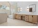 Elegant bathroom with double vanities, modern fixtures, soaking tub, stone wall, and contemporary mirrors at 4208 Antioch Church Rd # 1, Weddington, NC 28104