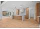 Spacious, modern kitchen with light wood flooring, cabinets and island, white countertops and backsplash, and stainless steel appliances at 4208 Antioch Church Rd # 1, Weddington, NC 28104
