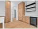 Well-lit modern kitchen featuring custom wood cabinets, open shelving, quartz countertops, and an adjacent archway at 4208 Antioch Church Rd # 1, Weddington, NC 28104