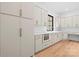Bright kitchen featuring white cabinets, gold hardware, an oven, and wooden floors at 4208 Antioch Church Rd # 1, Weddington, NC 28104