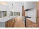 Bright kitchen features a large island, quartz countertops, stainless steel appliances, and natural wood cabinets at 4208 Antioch Church Rd # 1, Weddington, NC 28104