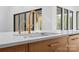 Close up of a kitchen island featuring quartz countertops, custom faucet and wood cabinets at 4208 Antioch Church Rd # 1, Weddington, NC 28104